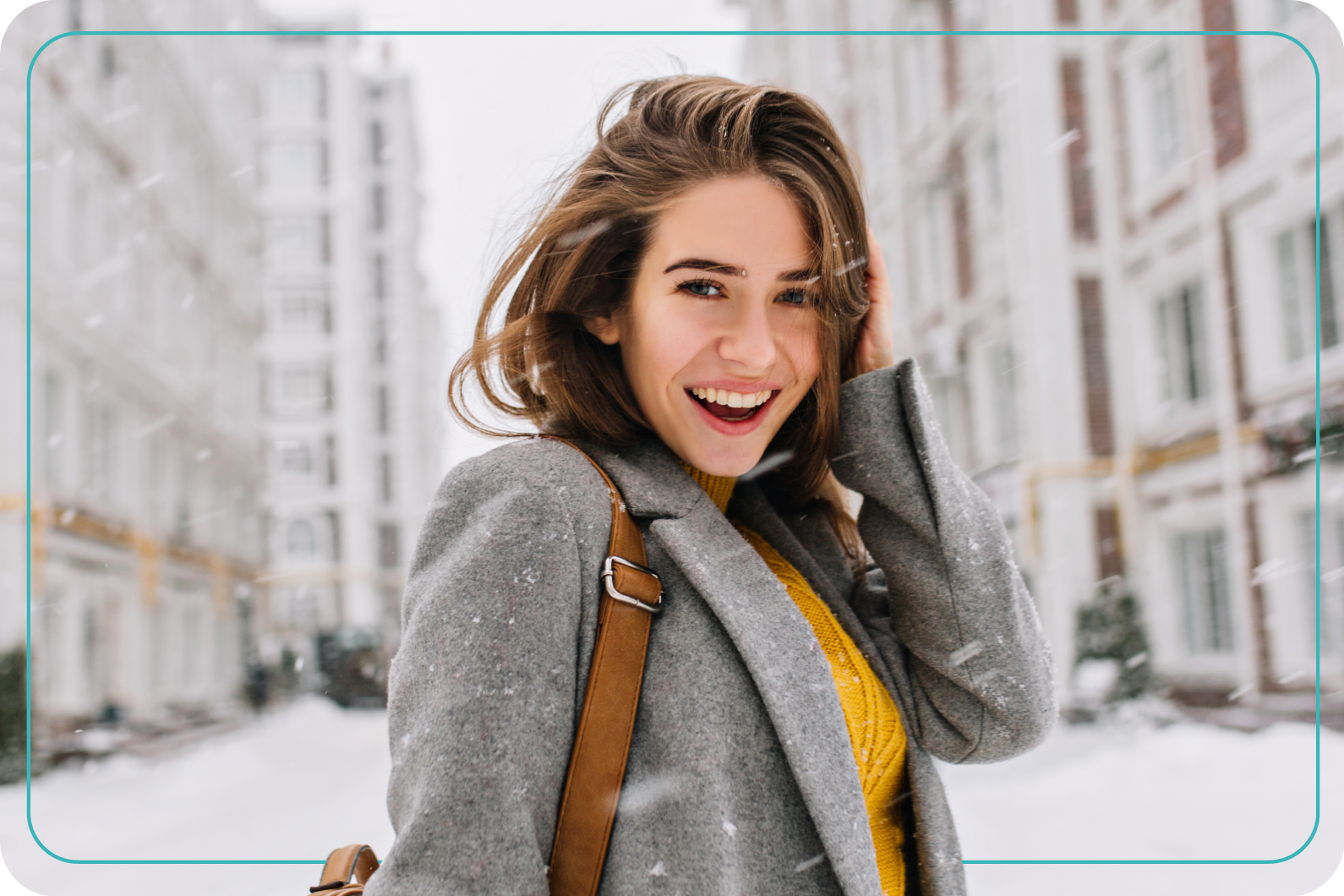 Mujer joven disfrutando del clima exterior mientras cae nieve en la ciudad